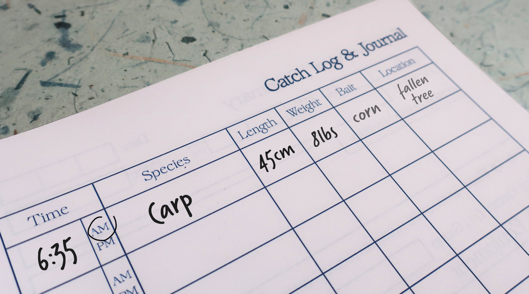 Fish catch log with details of a carp caught at 6:35 AM on a textured surface
