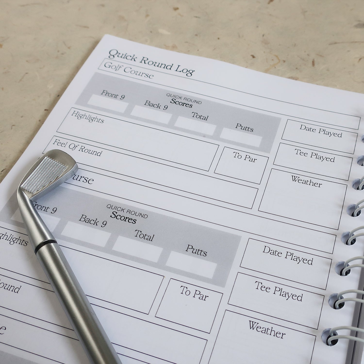 Golf Log Book Open On The Quick Round Log Page With A Miniature Golf Club Pen Laid Across It