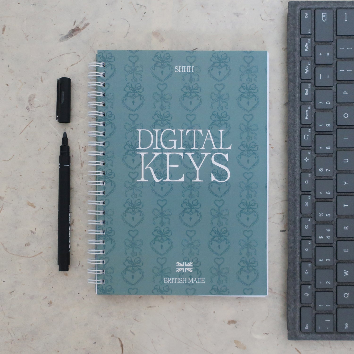 Address & password log book titled 'Digital Keys' with a pen and keyboard on a textured surface