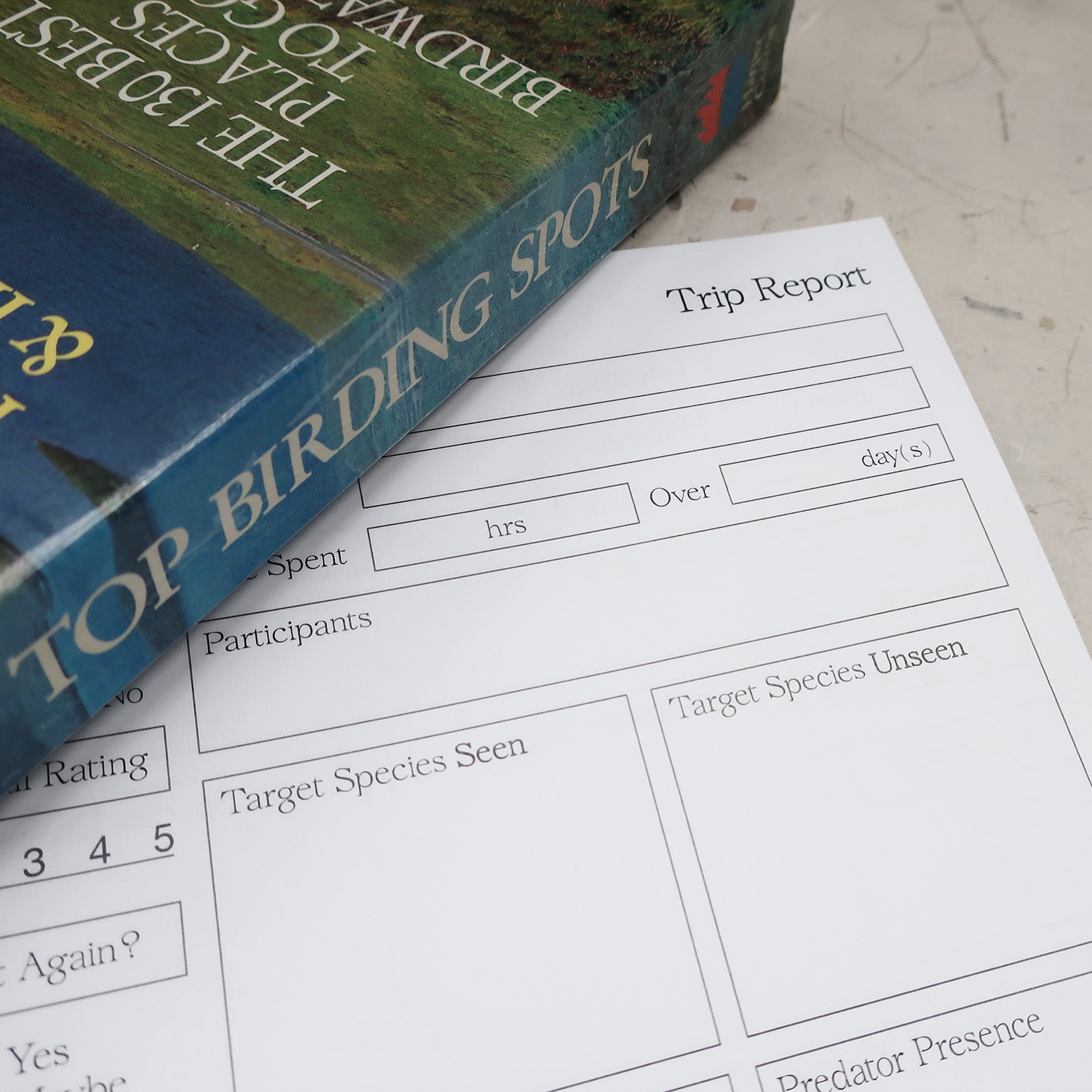 wayzgoose Bird Watching Log Book Open On The Trip Report Page, Laid On A Textured Background With A Vintage Top Birding Spots Book